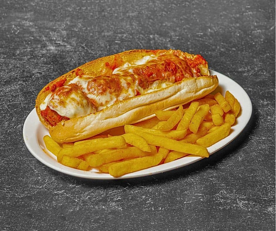 Meatball sandwich with melted cheese and marinara, served with fries