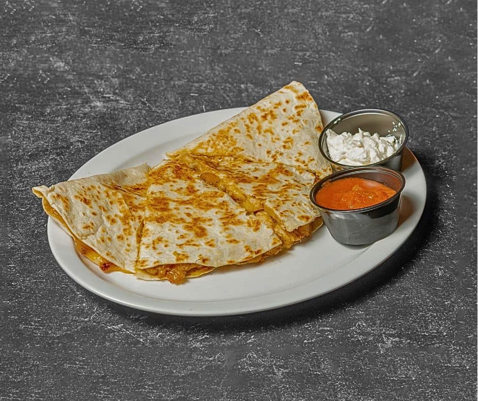 Quesadilla wedges with sour cream and salsa
