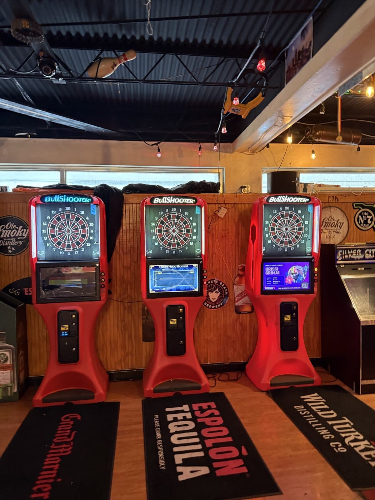 Three BullShooter electronic dart machines inside Play By Play Sports Bar