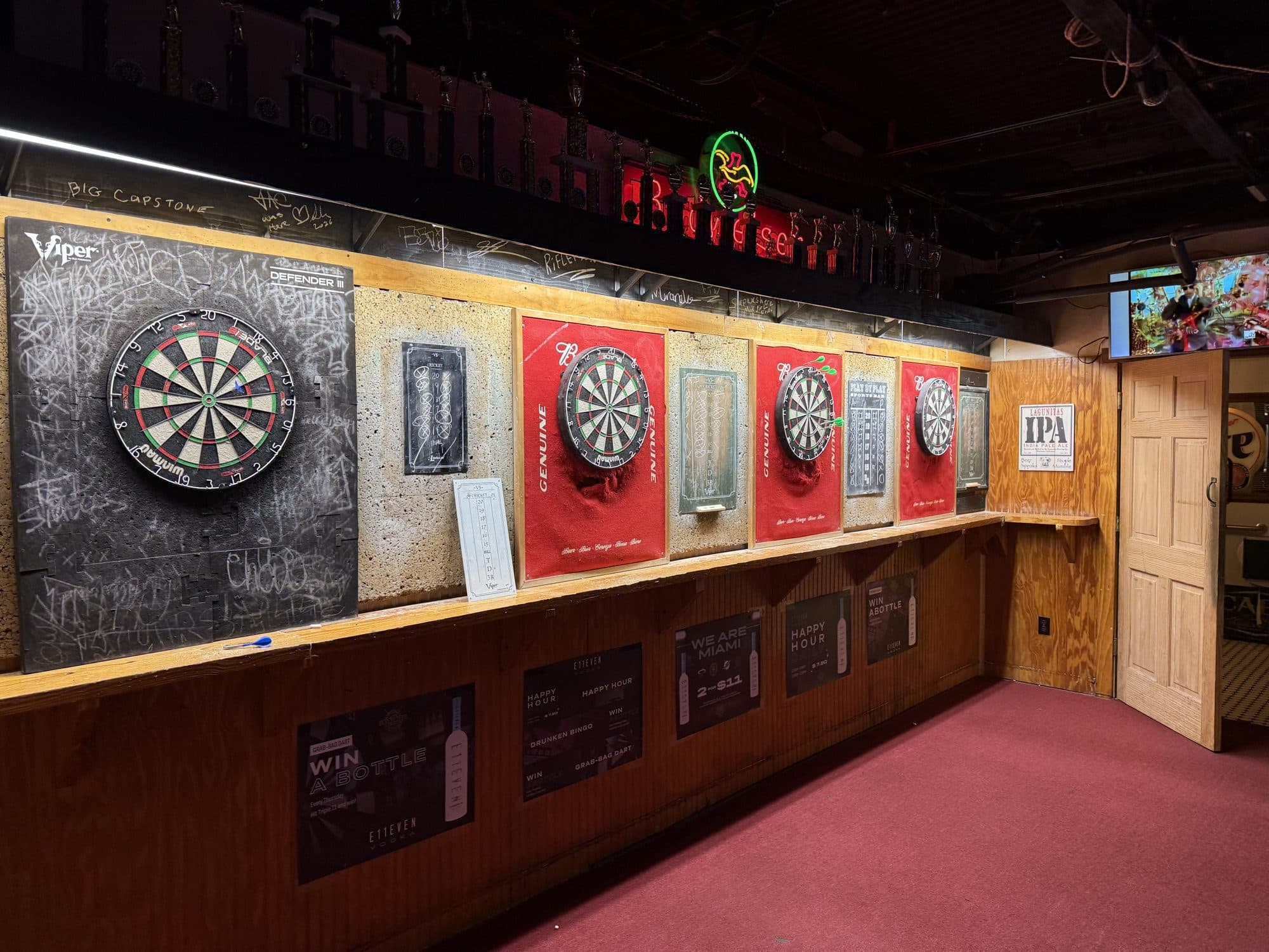 Row of traditional steel-tip dartboards at Play By Play Sports Bar