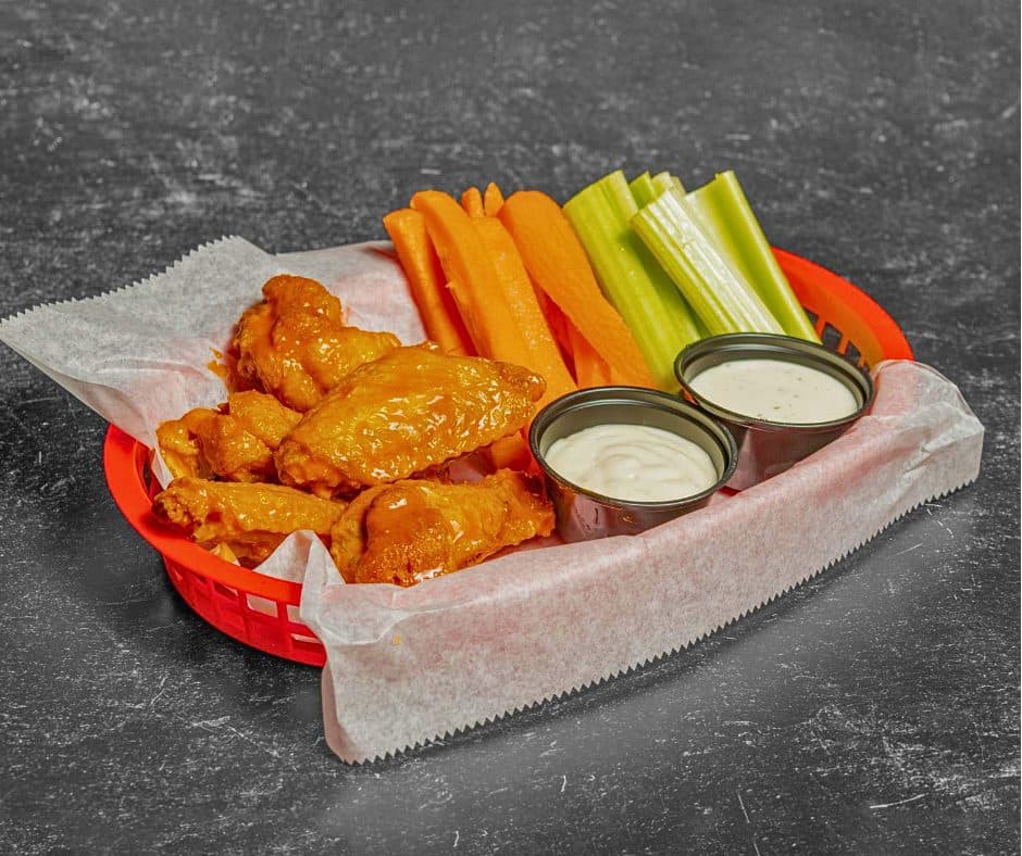 Basket of Play By Play wings with celery, carrots and ranch